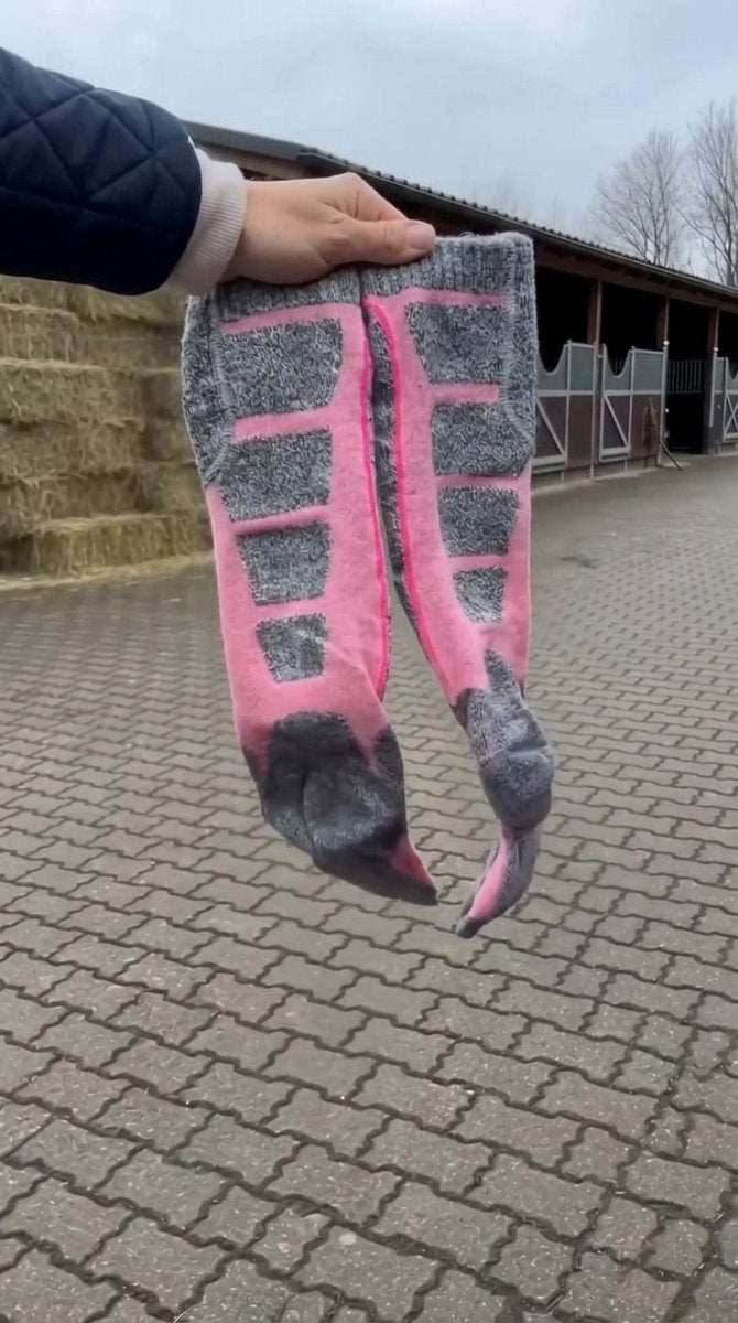 Cozy Canter heated riding socks held up at the barn