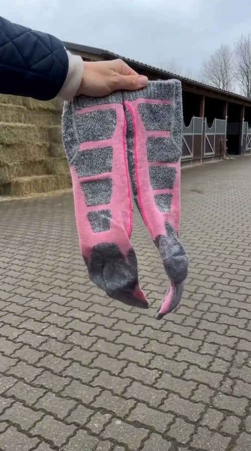 Cozy Canter heated riding socks held up at the barn